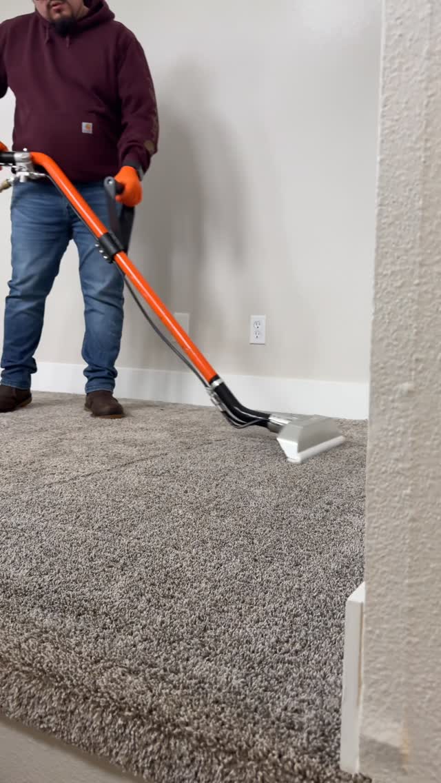 Empire Cleaning Services technician performing truck-mounted carpet extraction in a Portland-area residence