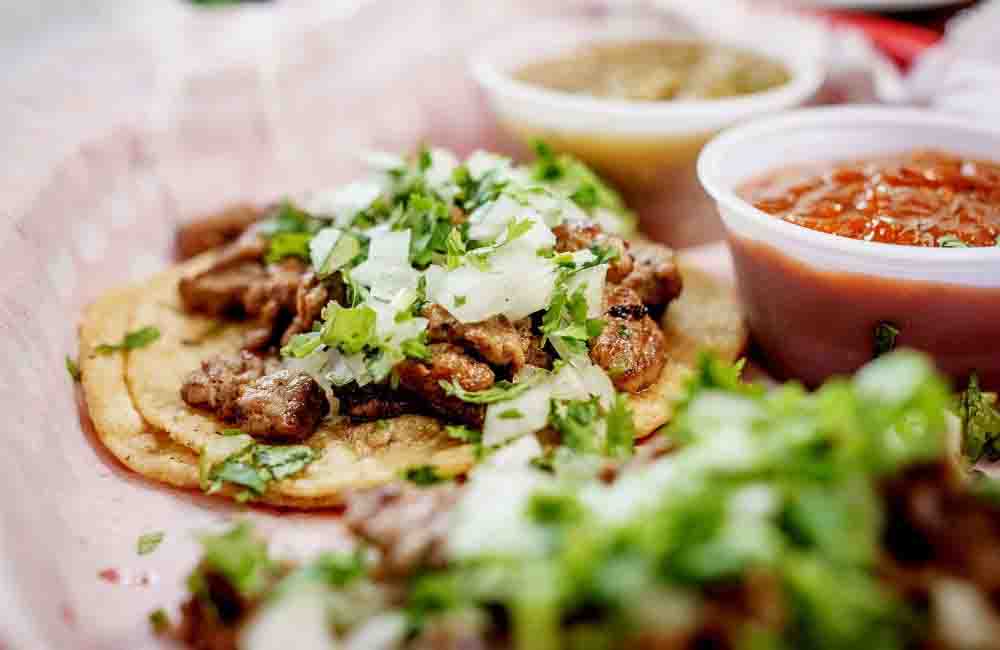Darn Good Tacos — marinated carne asada with cilantro, onion, and house salsas on warm corn tortillas