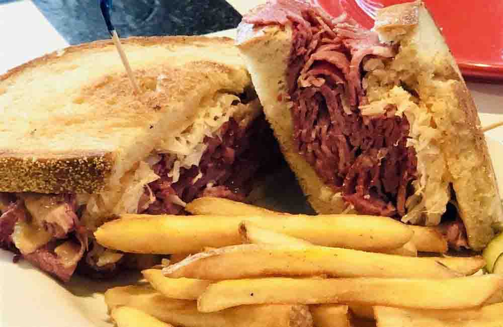 Mandy's Famous Reuben — house-smoked pastrami on grilled rye with sauerkraut and pub fries