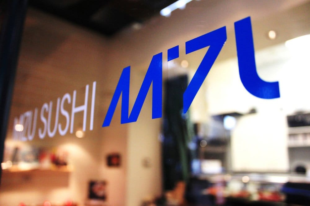 Mizu Sushi storefront — blue painted logo on glass